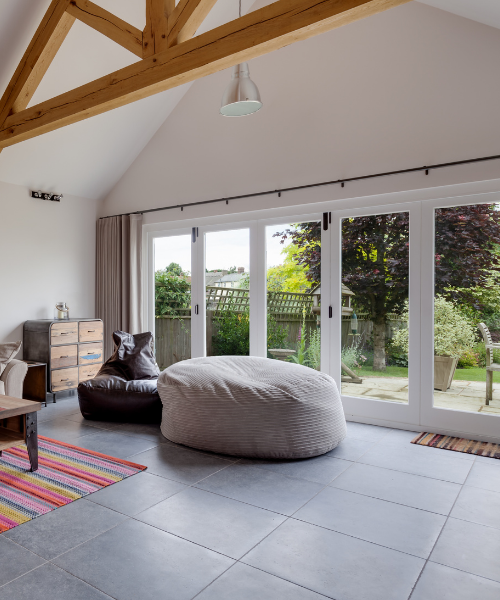 Bifold doors folded open across a living room wall