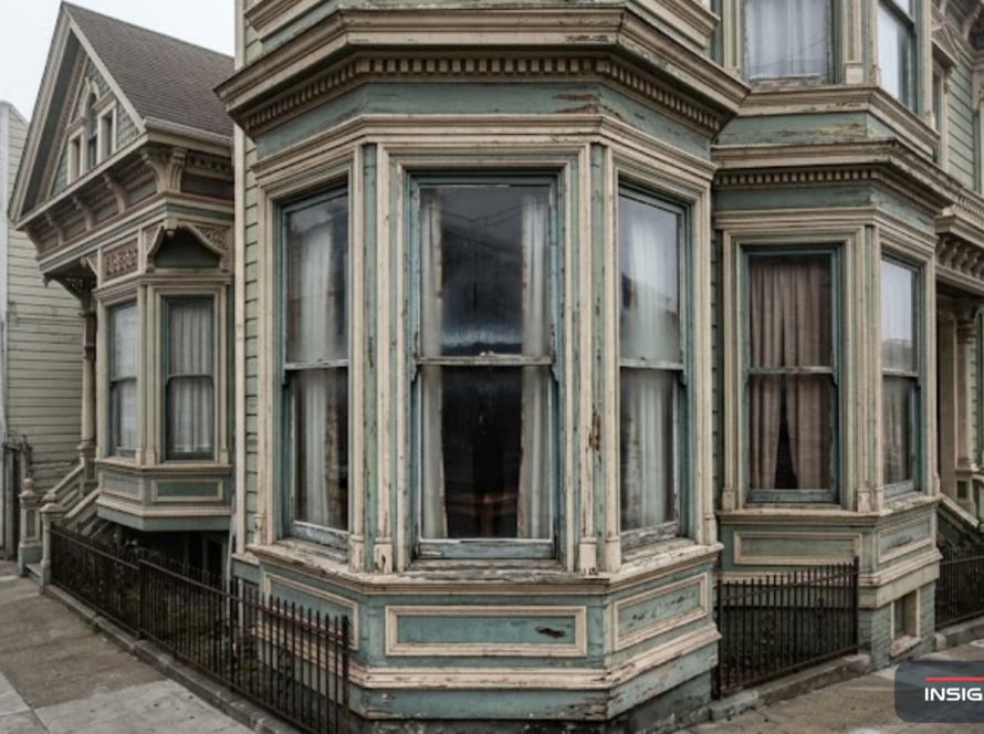 San Francisco Victorian row house facade with ornate aging bay windows on a foggy afternoon, illustrating the need for home window replacement in San Francisco's historic neighborhoods