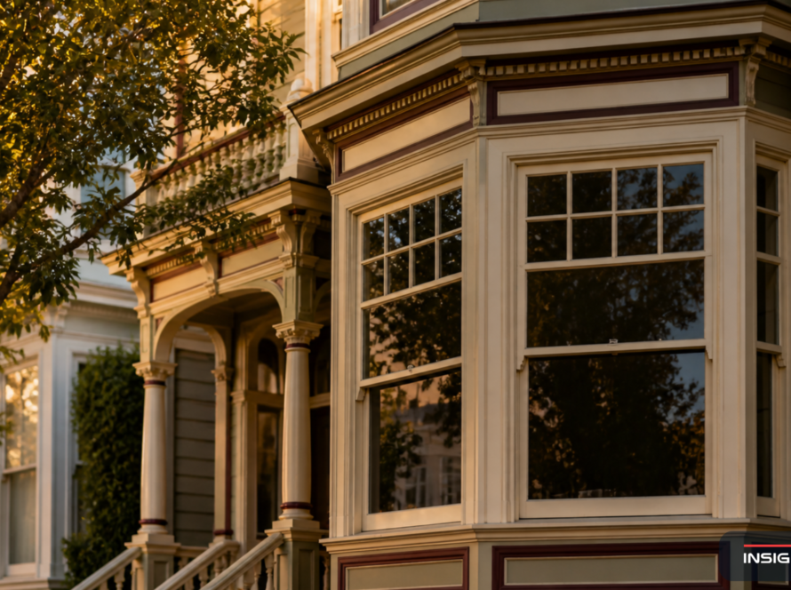 Classic San Francisco Victorian home facade with traditional 4-over-1 mullion-divided wood windows in late afternoon light, showing period-correct architectural detail.