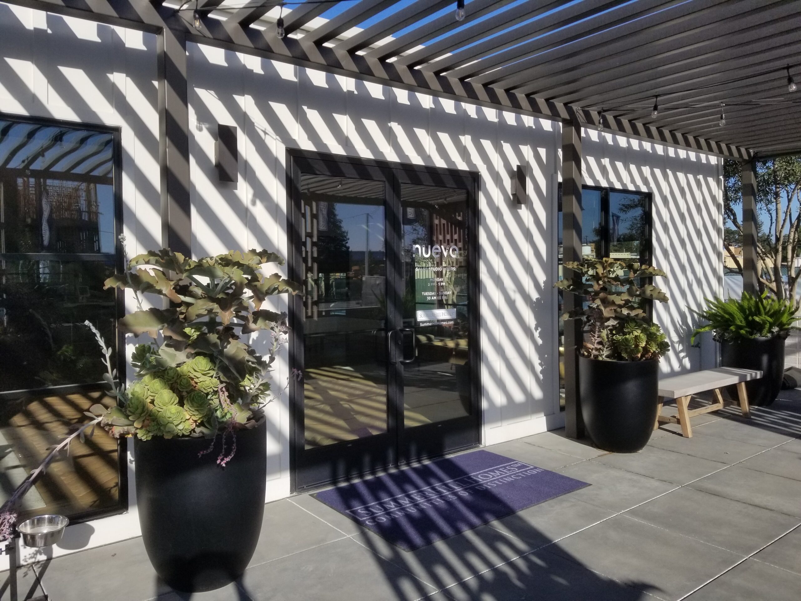 Completed commercial storefront entrance with black aluminum framing and glass double doors installed by Insight Glass